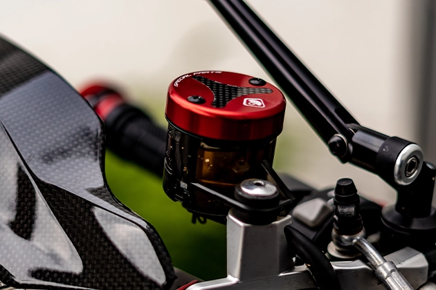 Close-up view of red anodised expansion tank cover with carbon inlet