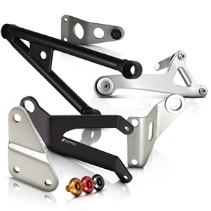 Various motorcycle exhaust brackets and accessories in black and silver.